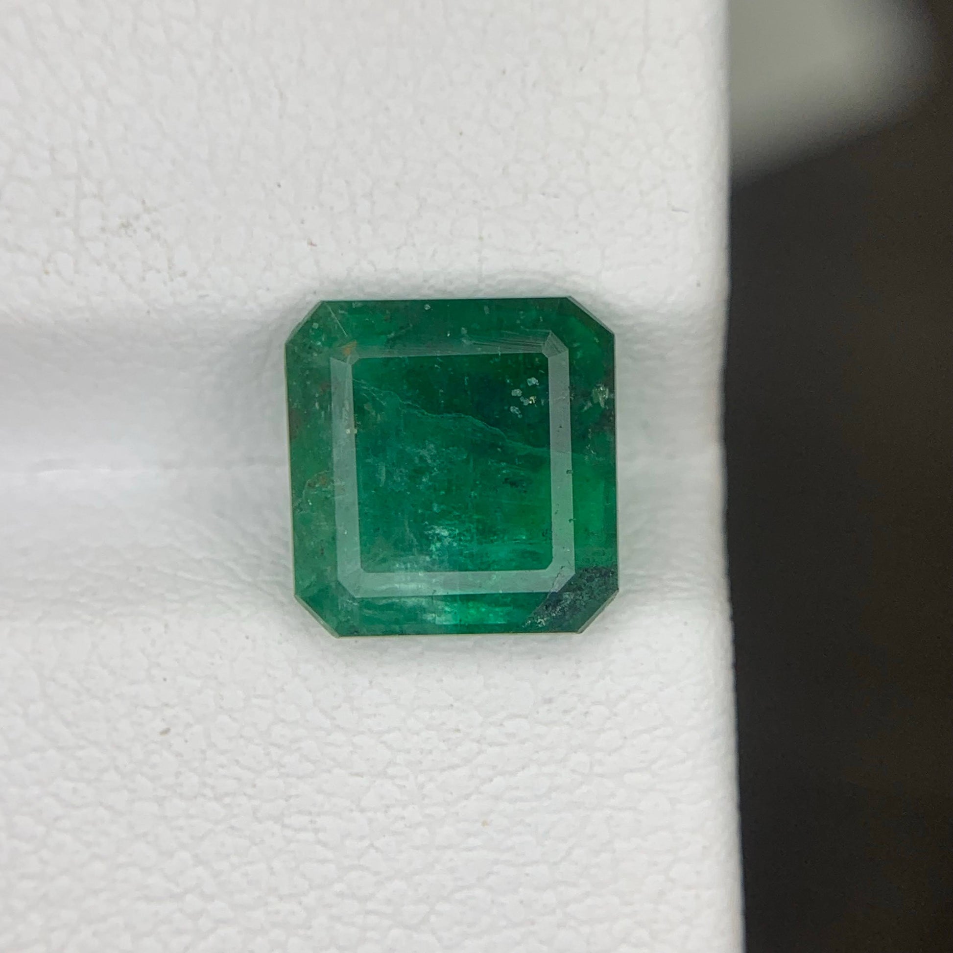 Green emerald gemstone on a white background