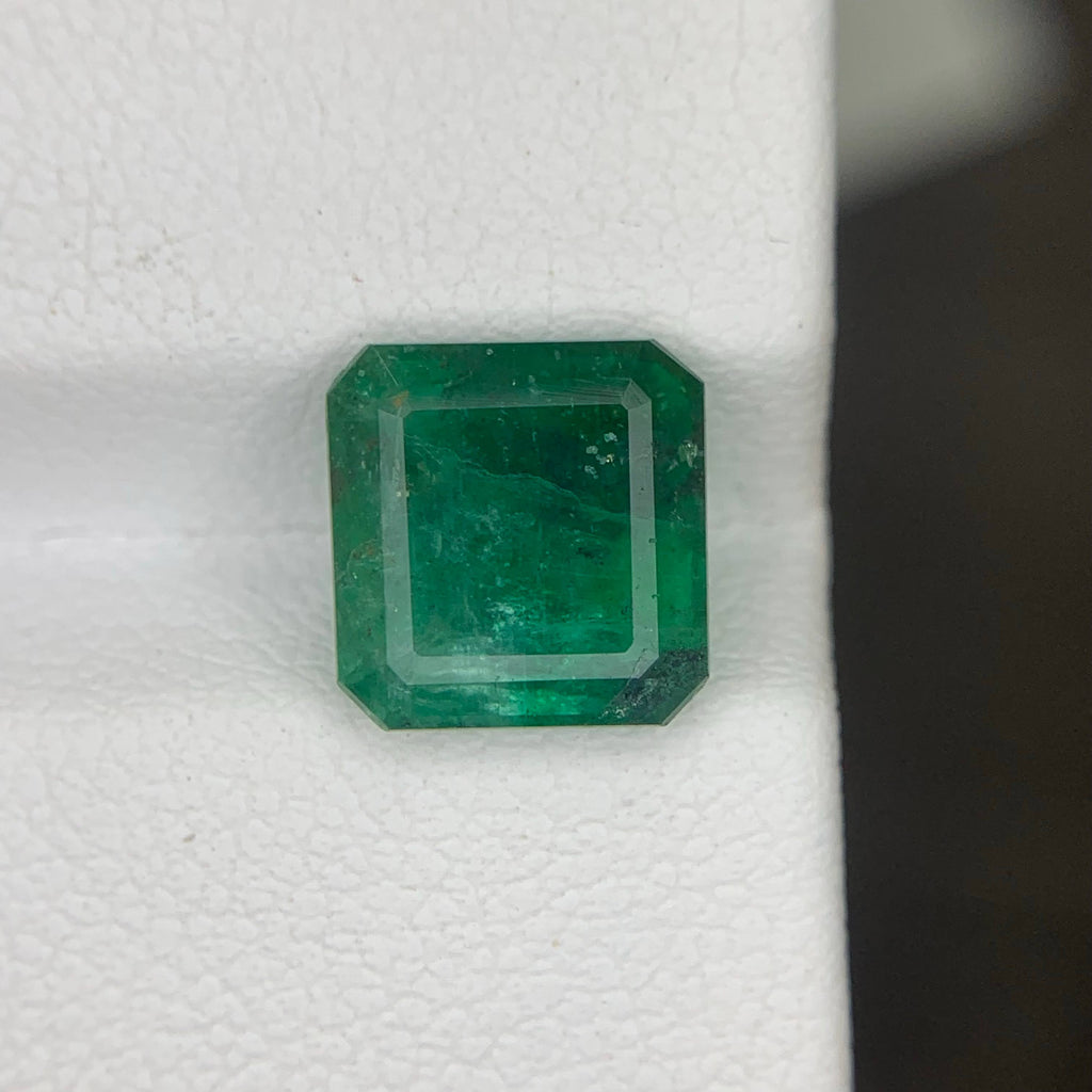 Green emerald gemstone on a white background