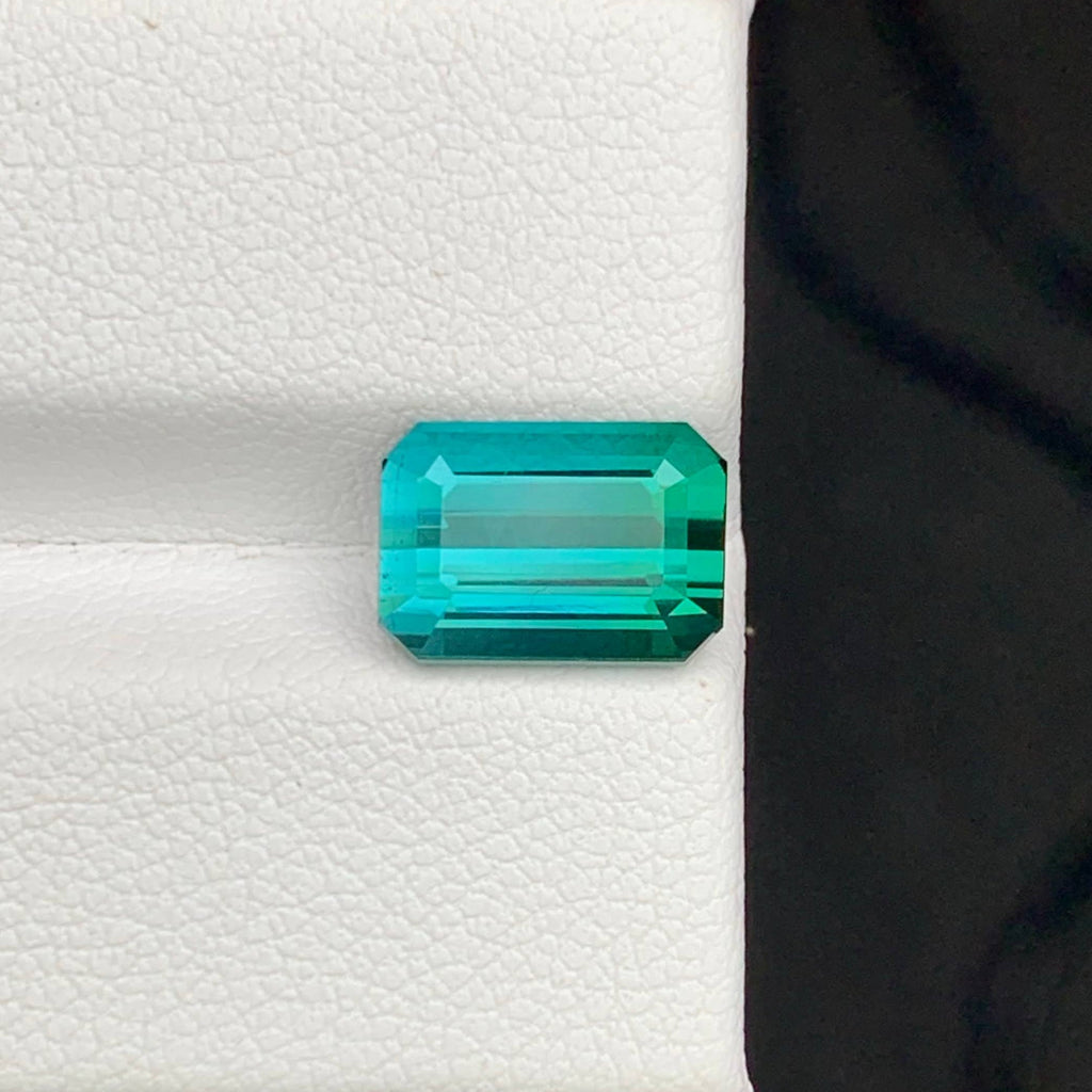 3.65 Carats Greenish Tourmaline Emerald-cut green gemstone on a white background