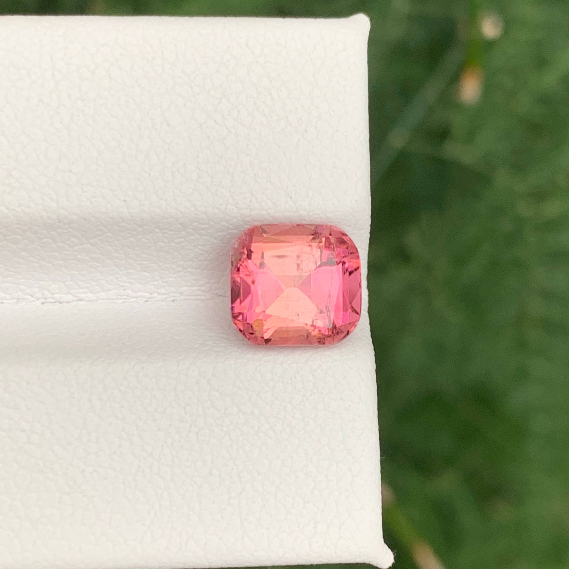 2.85 Carats Baby Pink Tourmaline Pink gemstone on a white cloth with a green leafy background