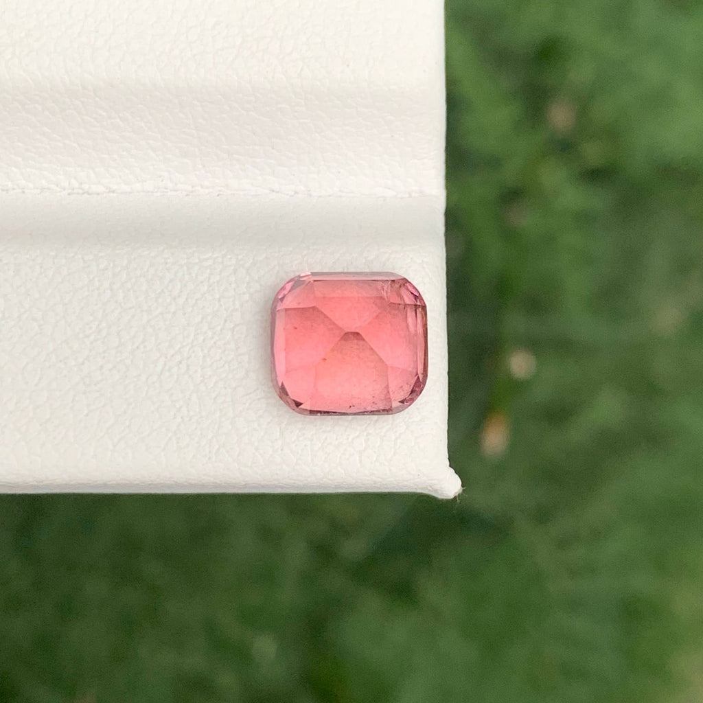 2.85 Carats Baby Pink Tourmaline Pink gemstone on a white cushion with a green leafy background