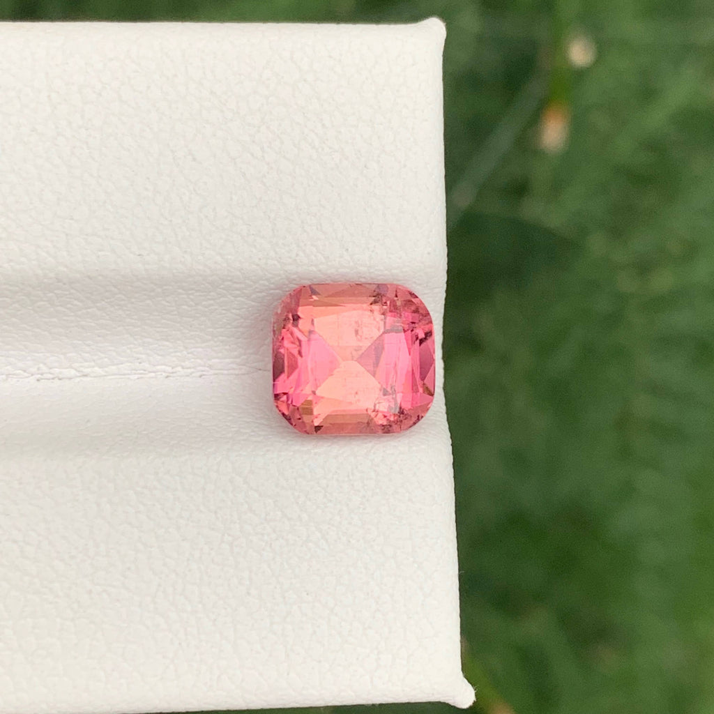 2.85 Carats Baby Pink Tourmaline Pink gemstone on a white cloth with a green background