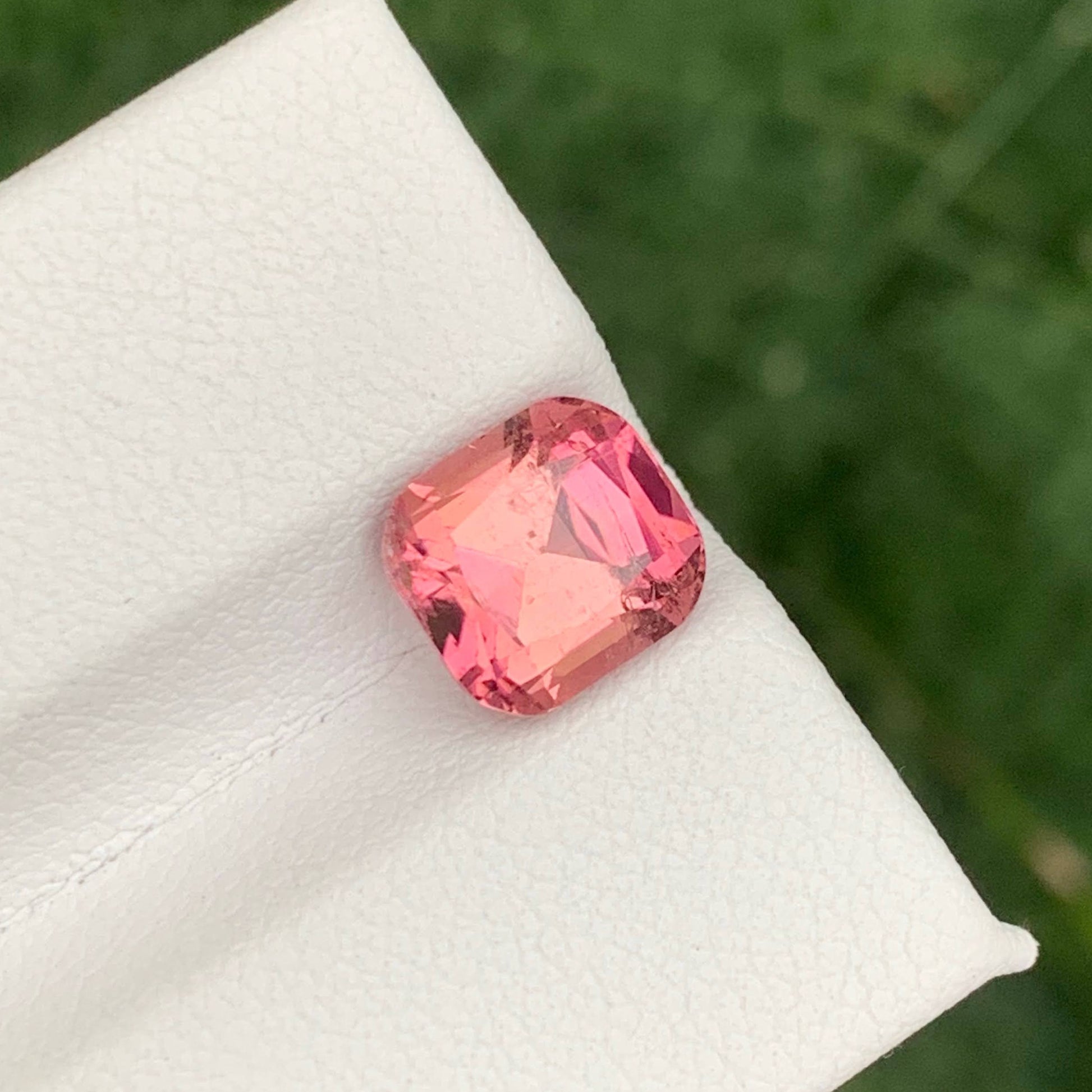 2.85 Carats Baby Pink Tourmaline Pink gemstone on a white cloth with a green leafy background