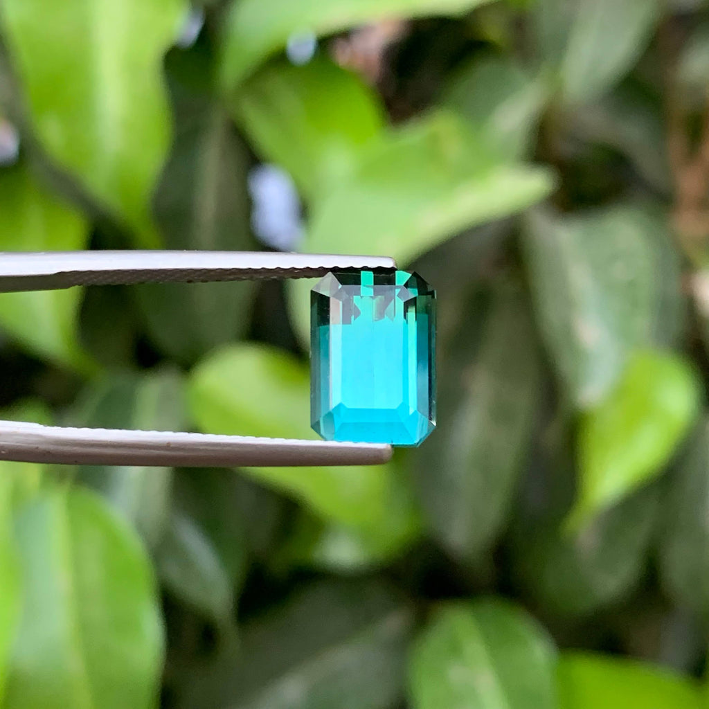 3.65 Carats Greenish Tourmaline Emerald-cut green gemstone on a white background