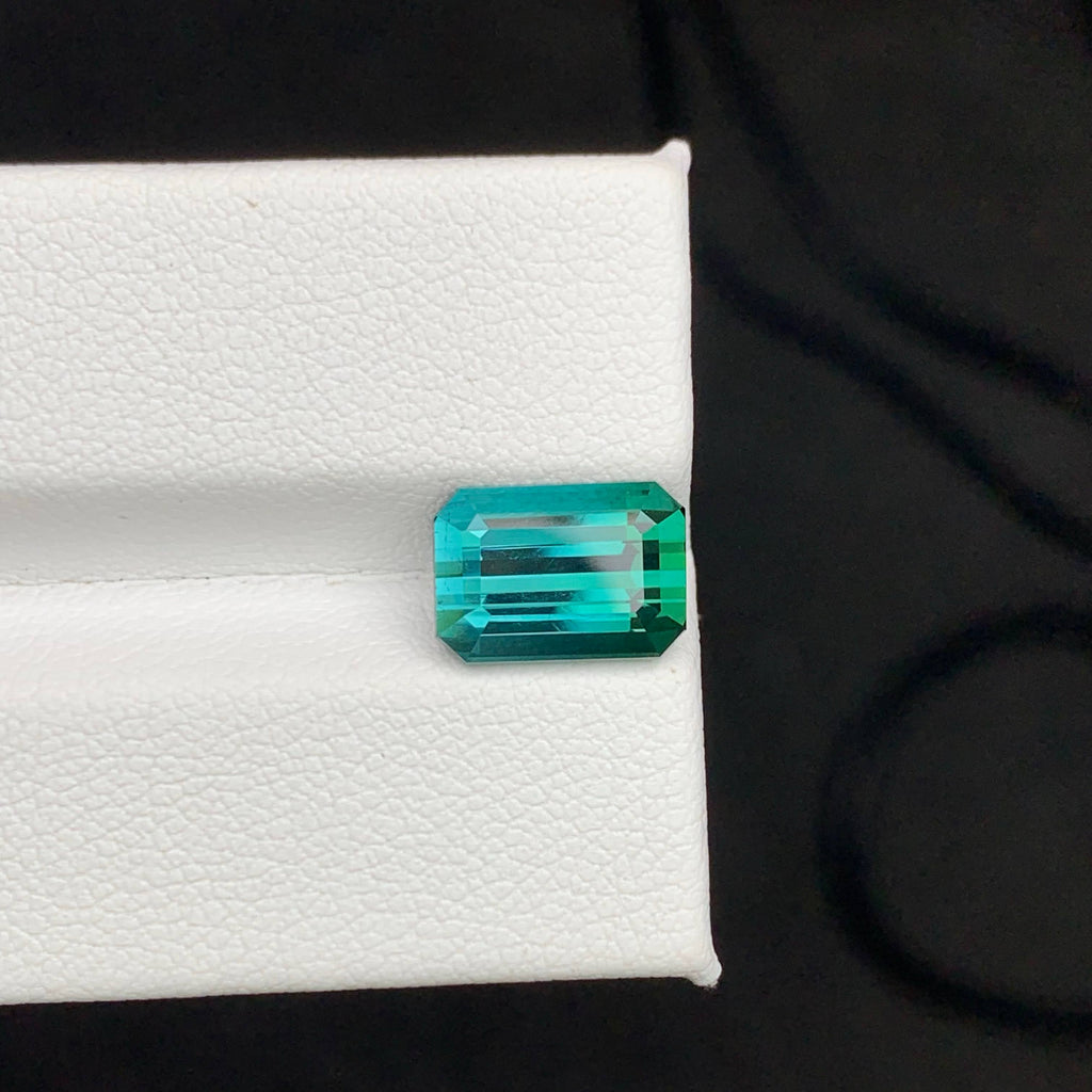 3.65 Carats Greenish Tourmaline Emerald-cut green gemstone on a white background