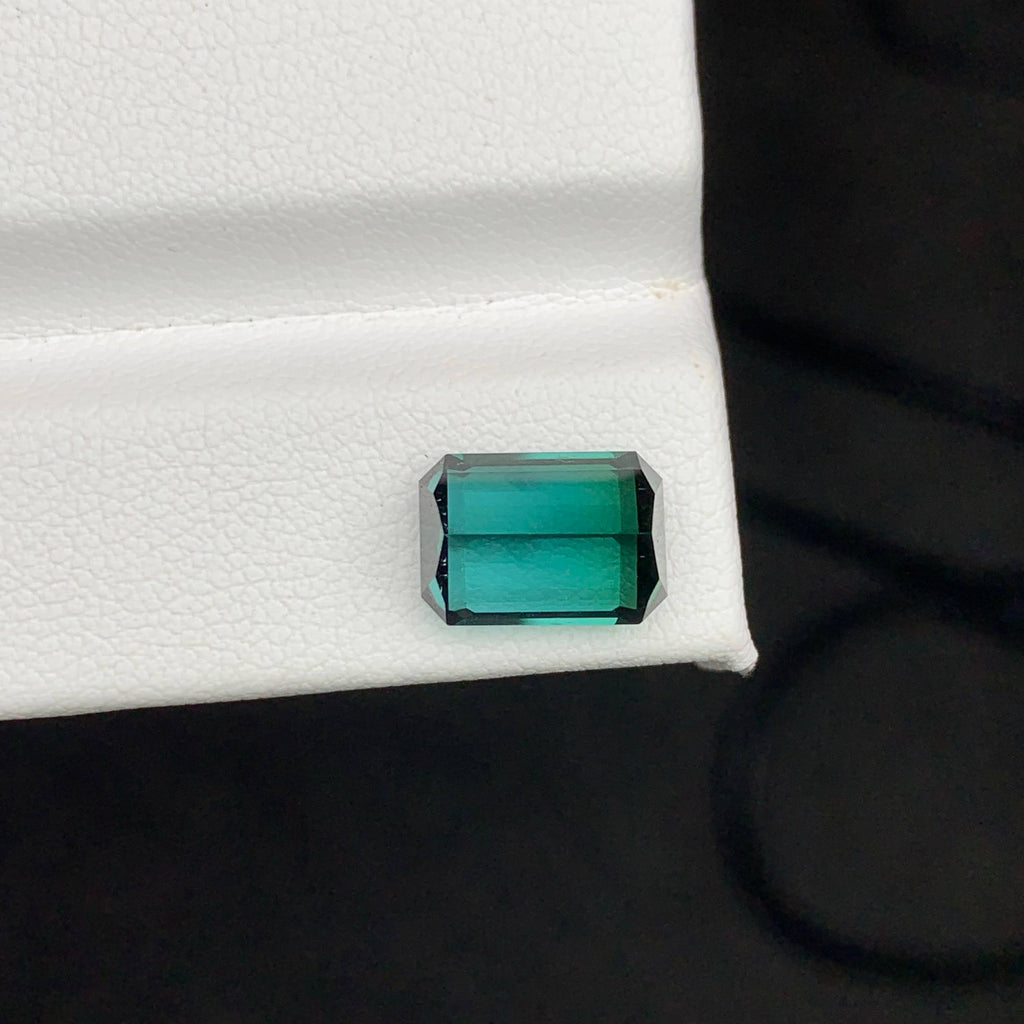 3.65 Carats Greenish Tourmaline Emerald-cut green gemstone on a white background