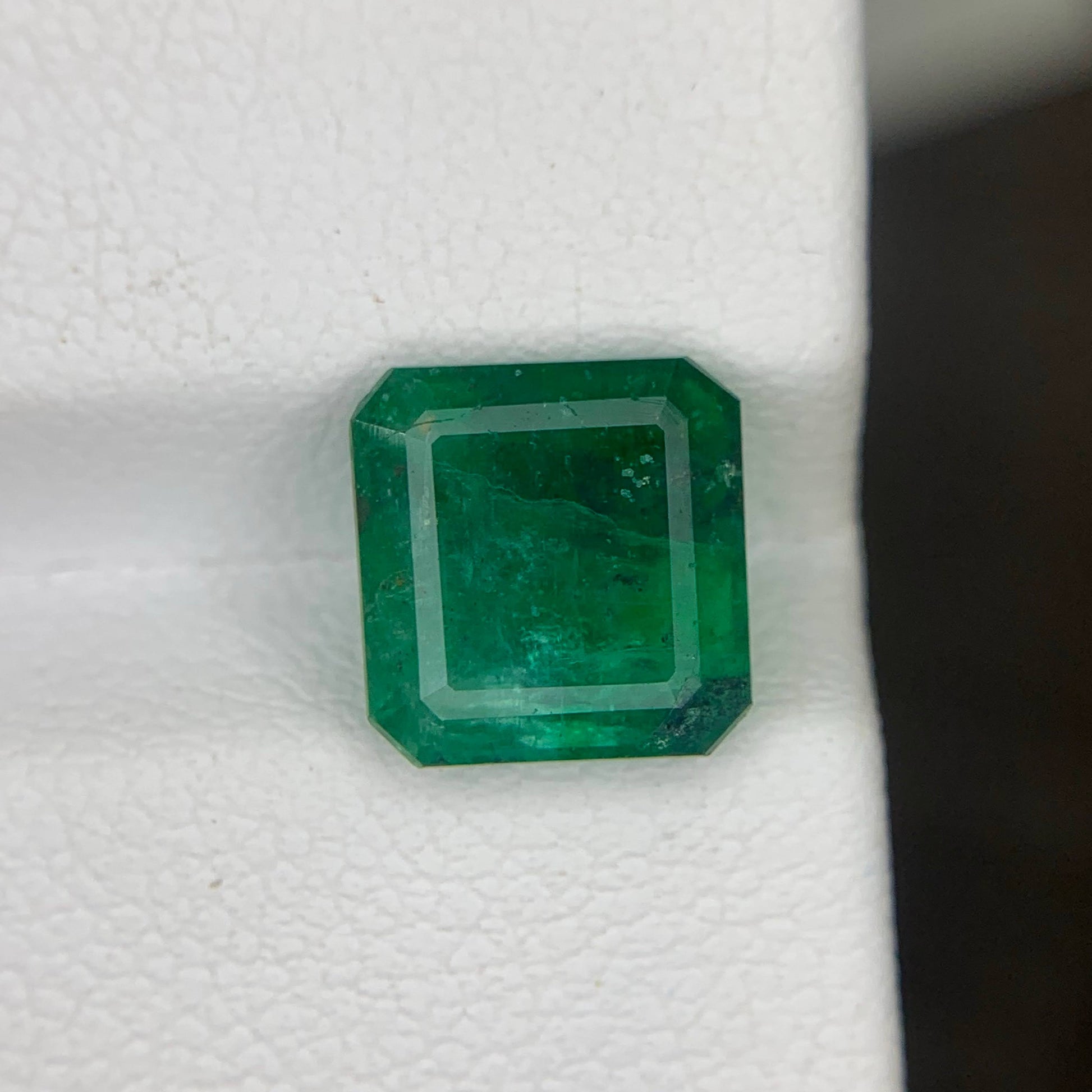 Green emerald gemstone on a white background