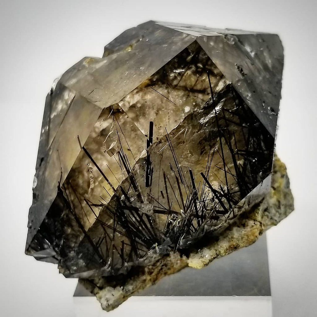 Mineral specimen with crystal structure on a white background