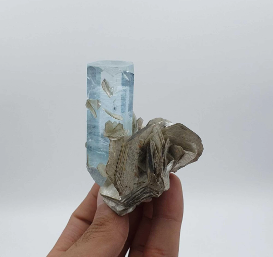 Multi Faced Gem Aquamarine on Silvery White Muscovite with Garnet
