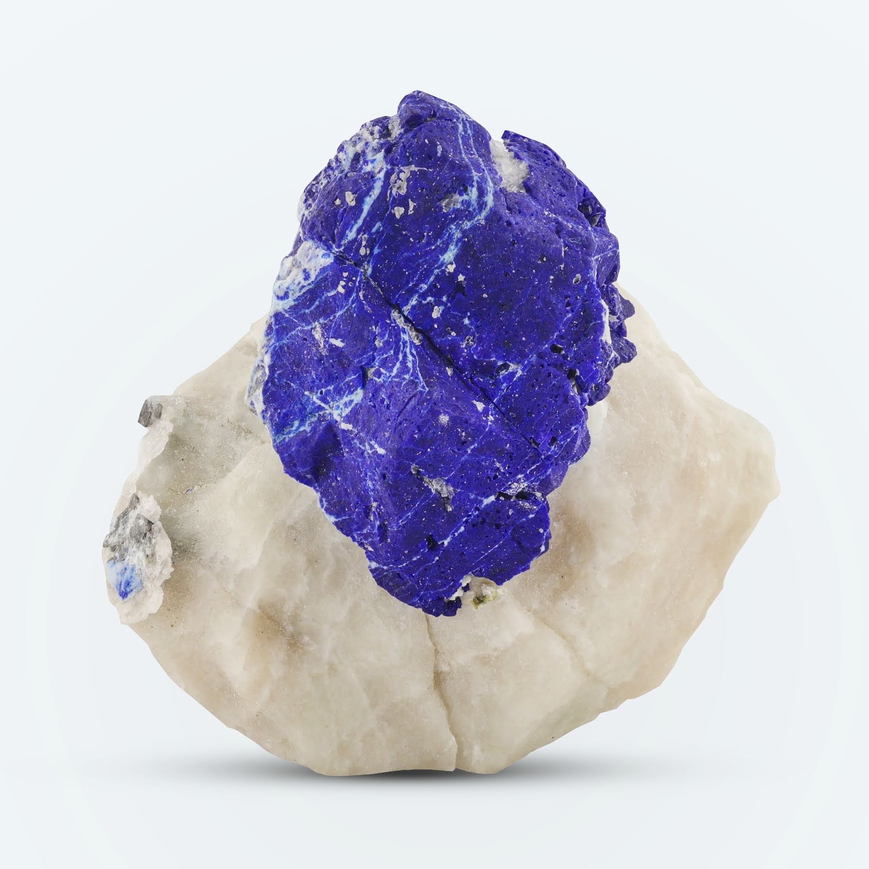 blue isolated Lazurite crystal on creamy white Calcite matrix from Afghanistan