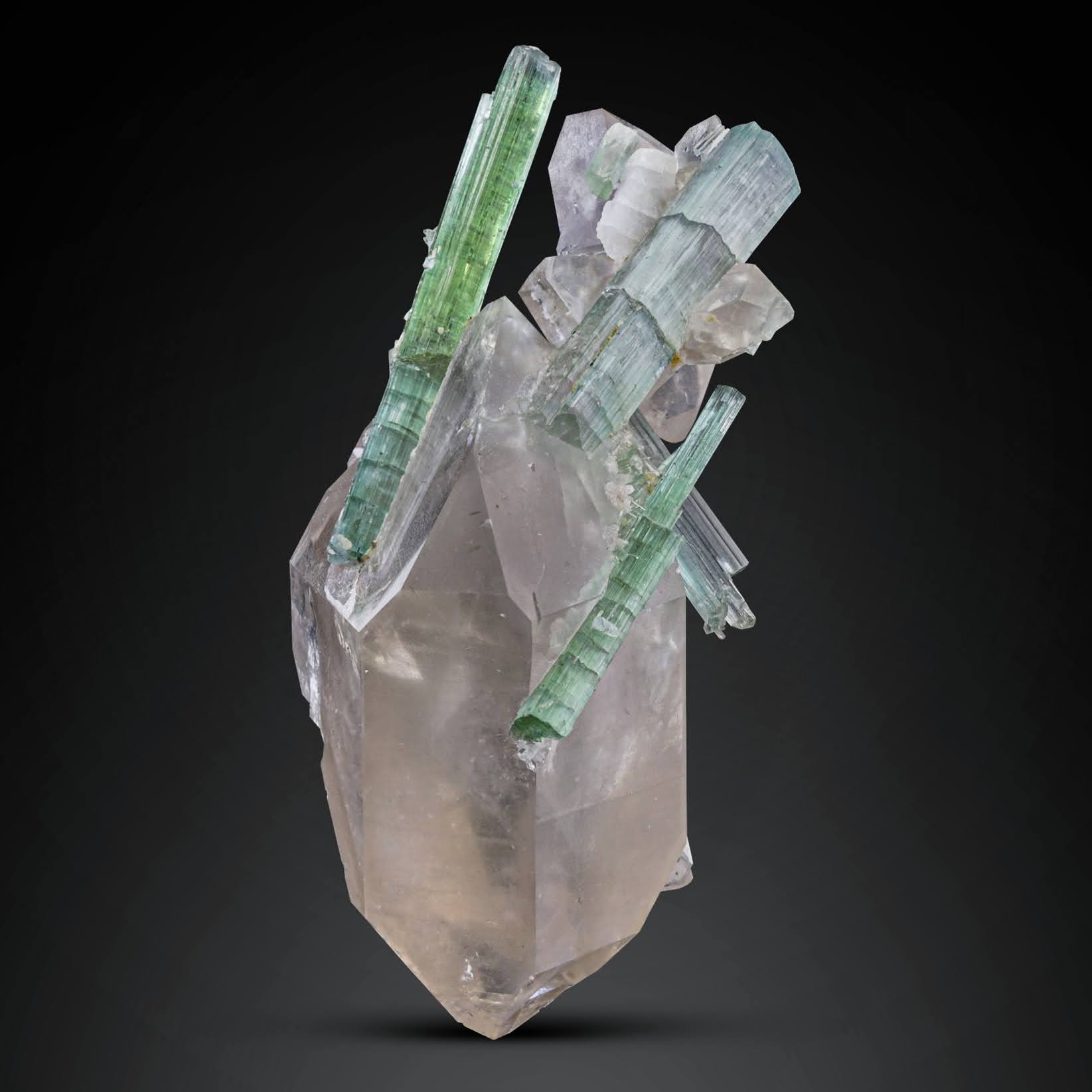 Green Tourmaline crystals perched on Smoky Quartz from Afghanistan