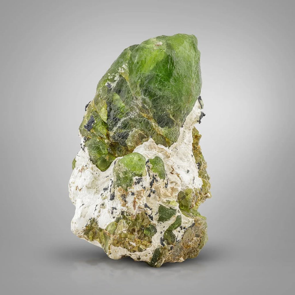Pointed Peridot Crystal Perched on Matrix with Magnetite from Pakistan