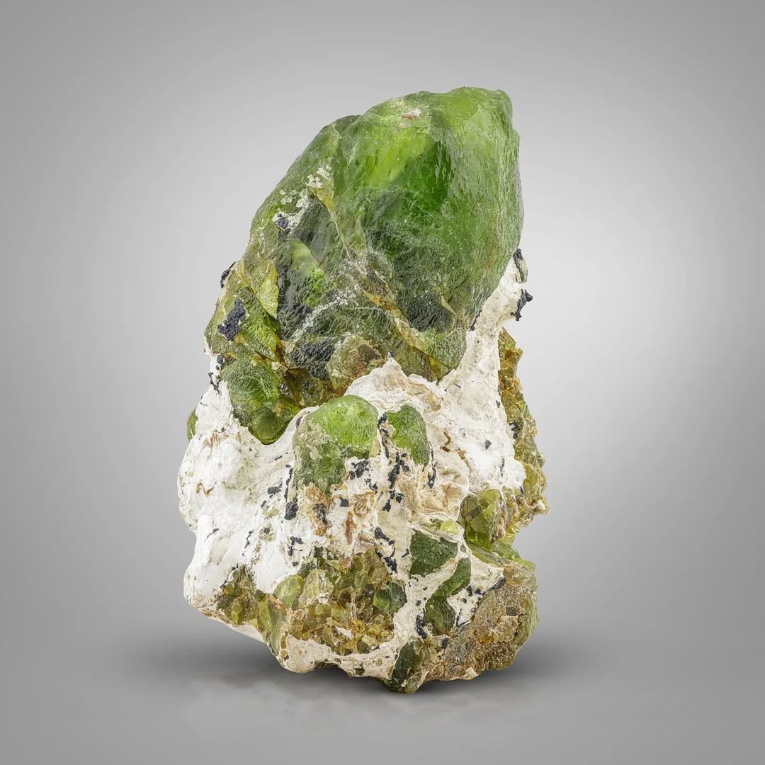 Pointed Peridot Crystal Perched on Matrix with Magnetite from Pakistan