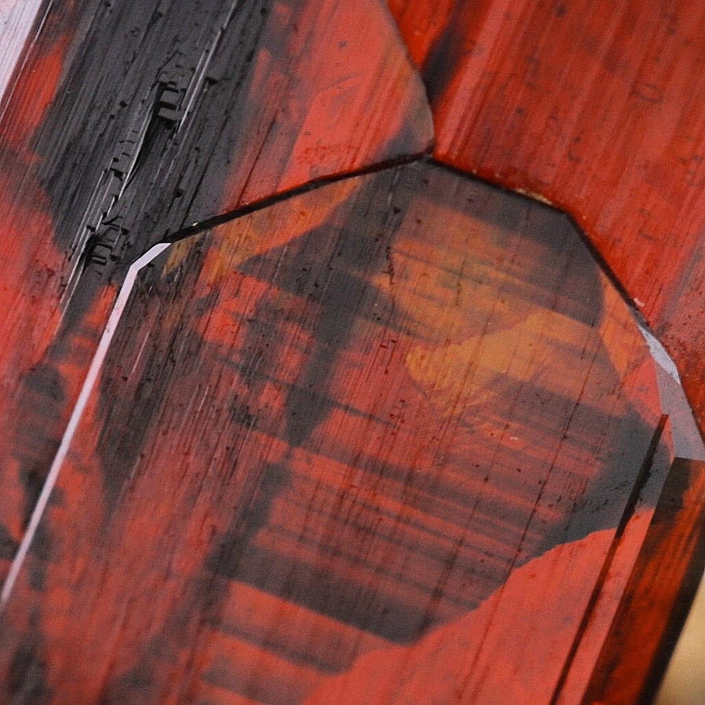 Thick blood red compact Brookite crystal perched on Quartz from Pakistan