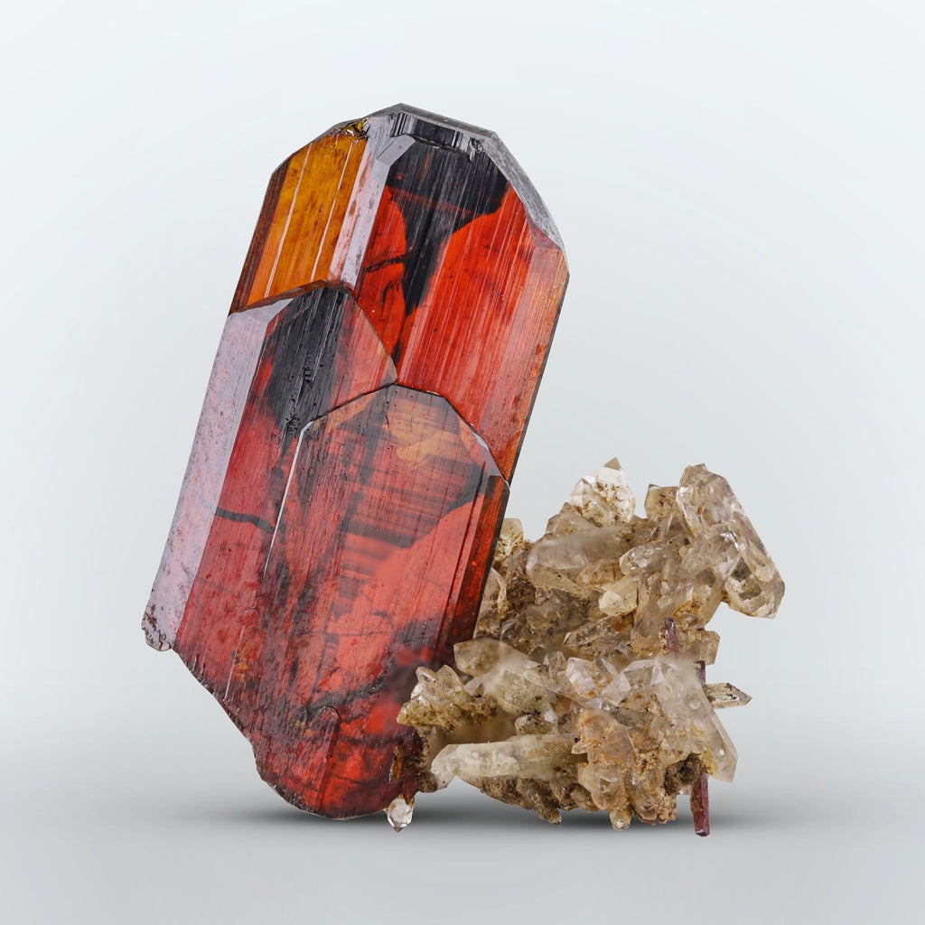 Thick blood red compact Brookite crystal perched on Quartz from Pakistan