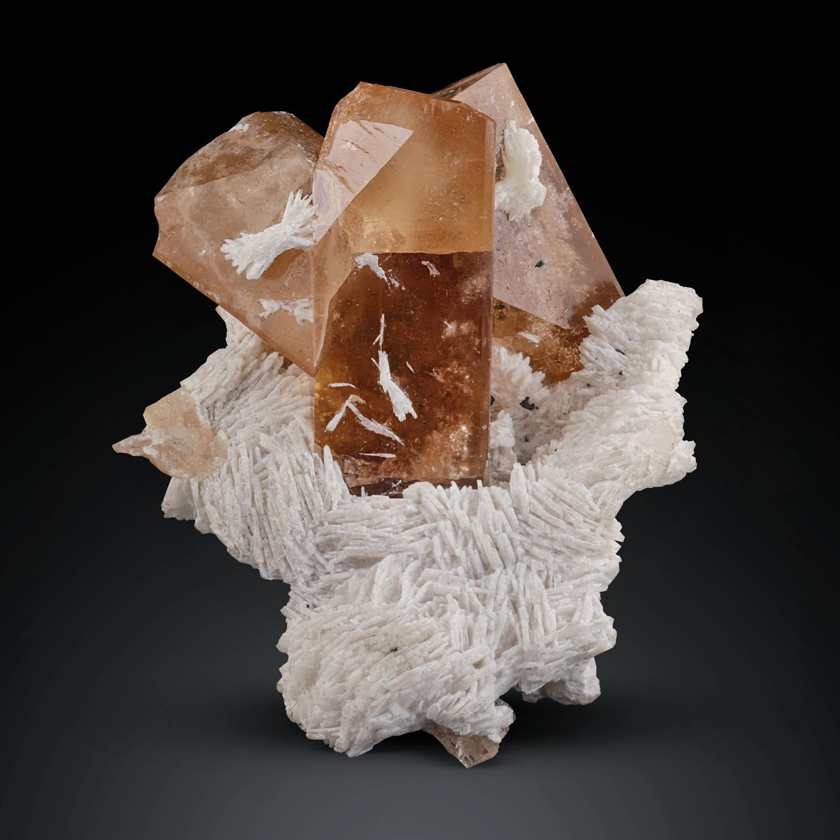 trio of Topaz crystals on cleavelandite matrix from Pakistan